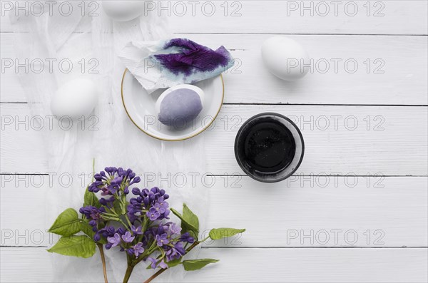 Top view dyed eggs easter with lilac flowers