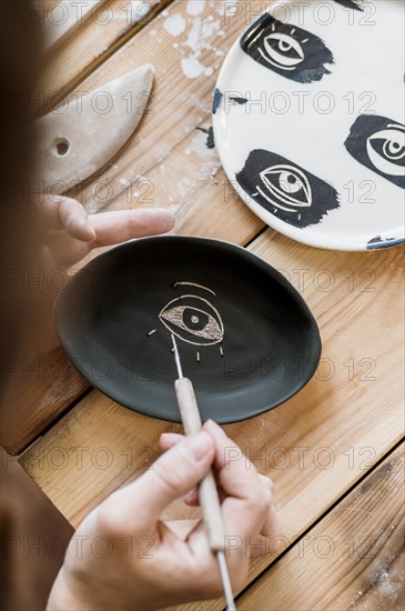 Woman doing pottery masterpiece her workshop