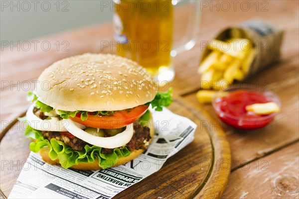 High angle close up burger with fries wooden board