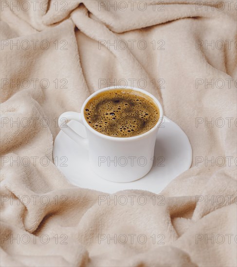 High angle morning cup coffee bed