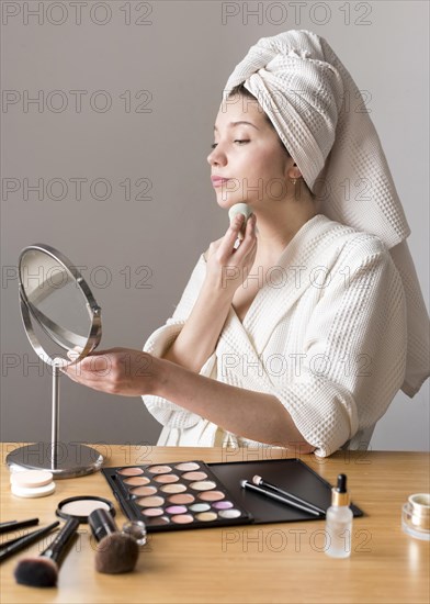 Portrait woman make up with sponge mirror