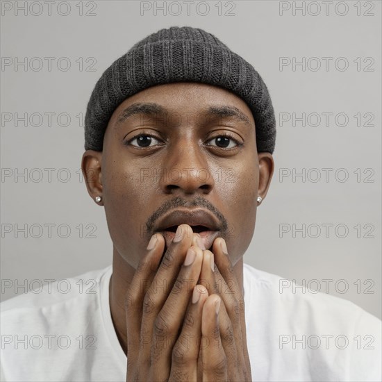 Portrait young man wearing cap posing