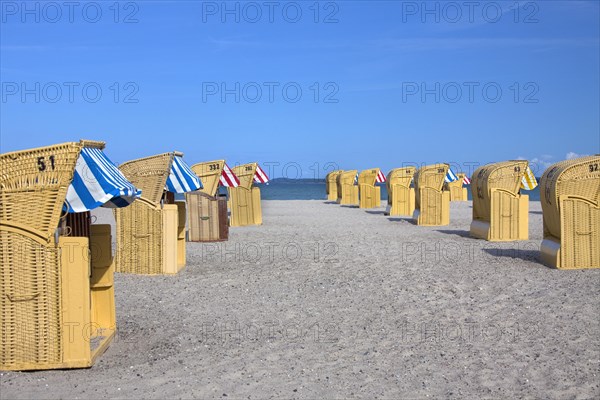 Roofed wicker beach chairs on the beach at Travemuende