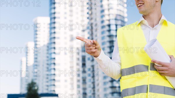 Close up man with safety vest pointing something