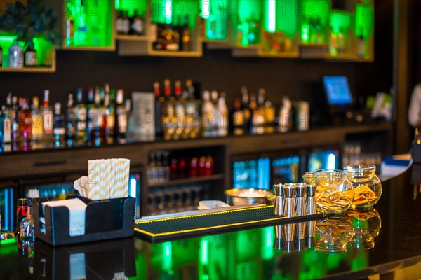 A luxury cocktail bar counter at night with no people