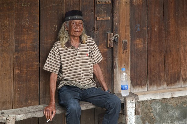Indonesian elderly man wearing traditional songkok