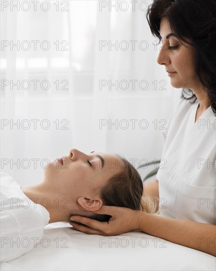 Osteopathist treating patient indoors