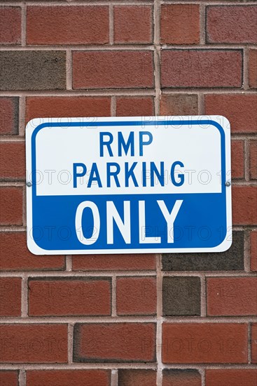 Parking sign brick wall closeup