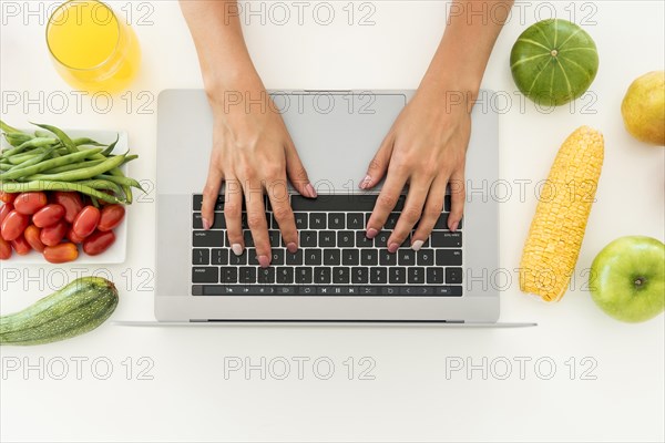 Top view laptop surrounded by fruit