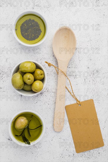 Top view olives oil with spoon