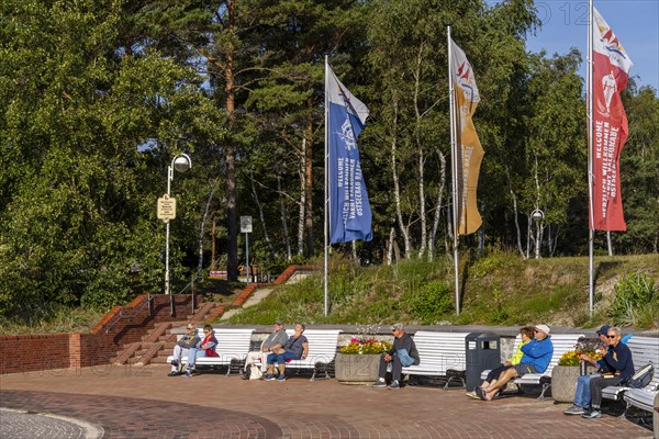 Senior citizens and holidaymakers on the beach promenade