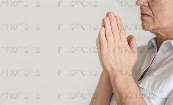 Side view woman praying with copy space