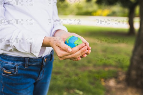 Midsection girl holding globe cupped hands