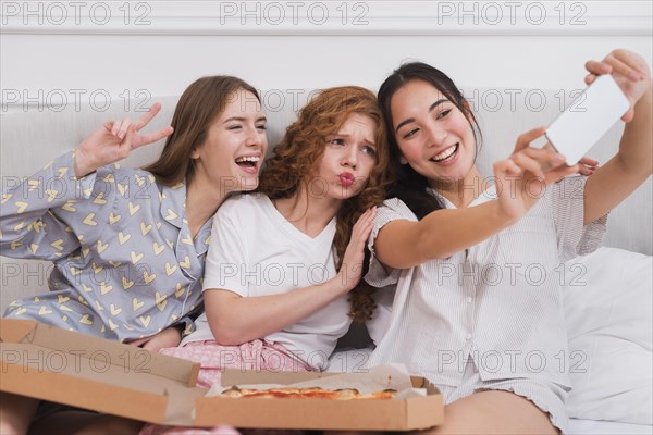 Playful girlfriends taking selfie