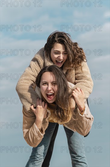 Smiley women posing together outdoors