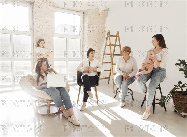 Women white shirts looking baby girl