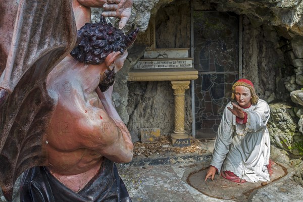 Sculpture of the devil and St Anthony of Padua at grotto in the village Crupet