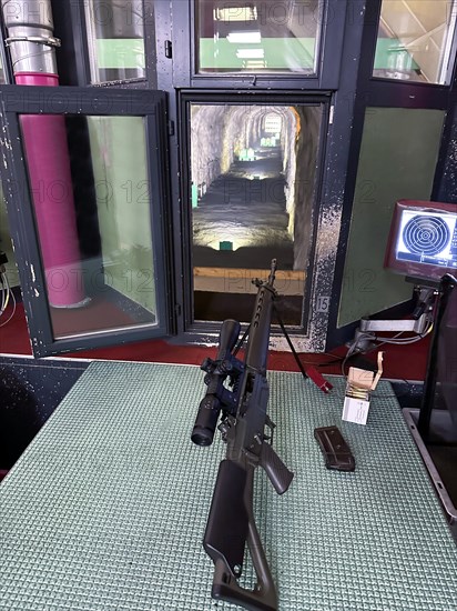 Modern 300 Meters Shooting Range with an Assault Rifle in an Illuminated Underground Tunnel in Switzerland