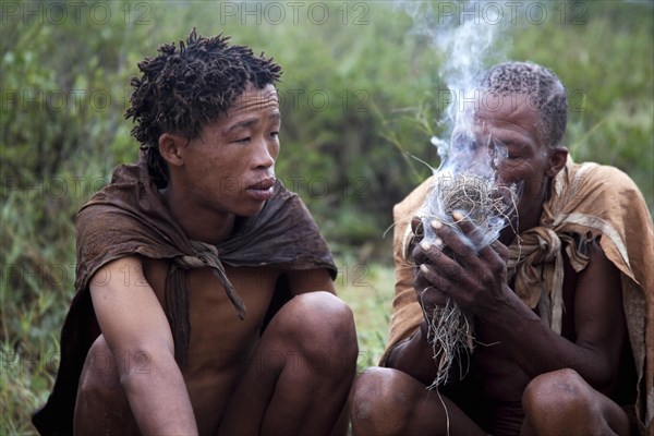 Bushman making fire in the Kalahari desert near Ghanzi