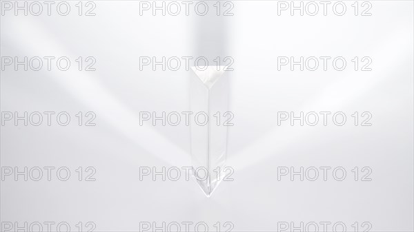 Prism dispersing sunlight white background