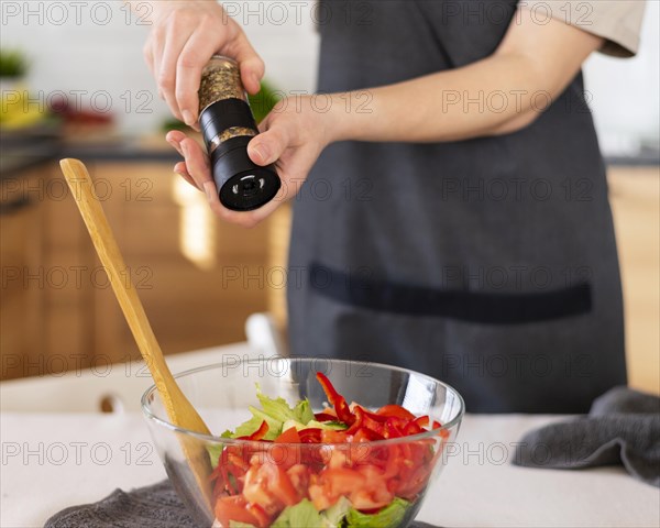 Close up hands spicing food