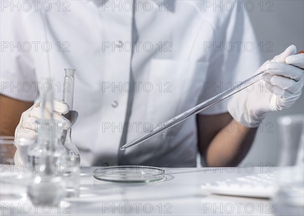 Close up hands holding laboratory glassware