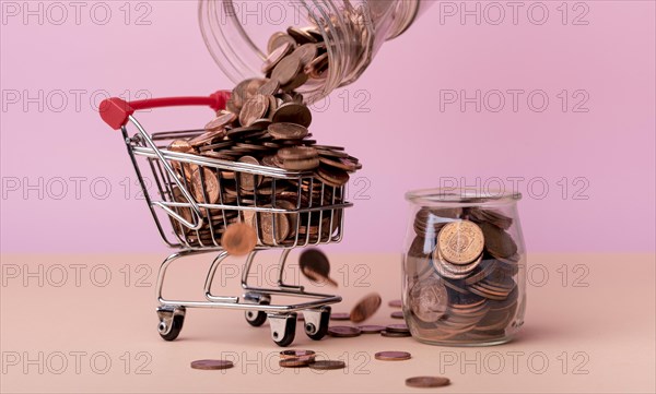 Front view shopping cart with lots coins jar