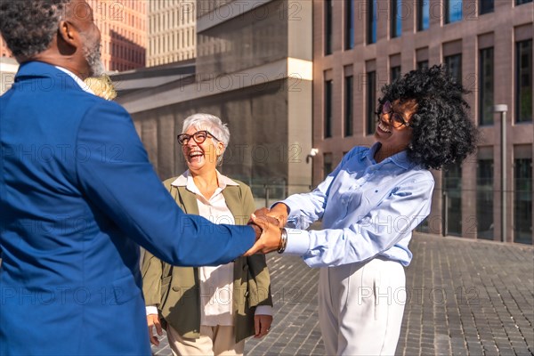 African business people shaking hands when they meet outdoors next to other people