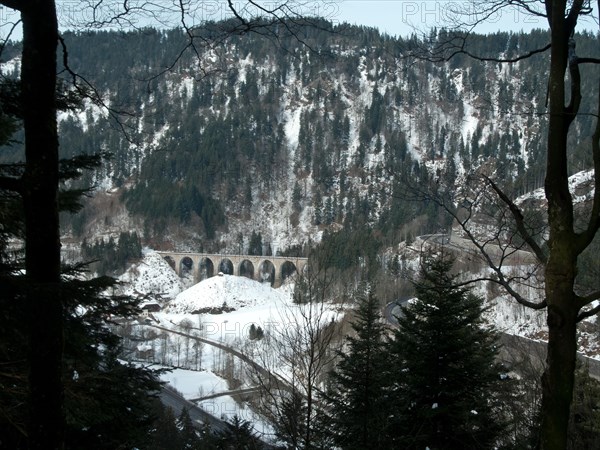 View from the Bister waterfall to the hairpin bends of the main road through the Hoellental valley and to the stone arch railway bridge over the Ravenna gorge