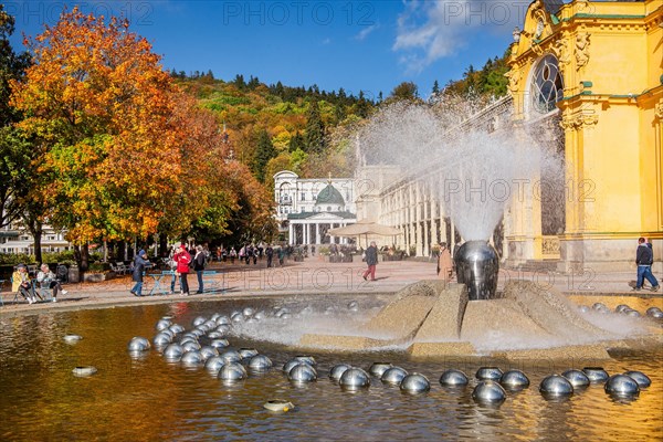 Spa colonnade with singing fountain in the autumnal spa park