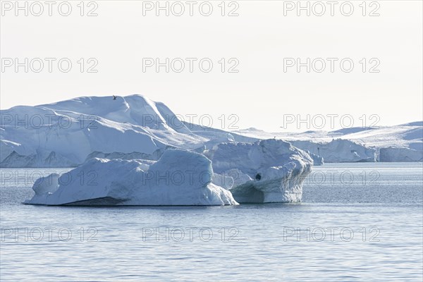 Icebergs in the UNESCO World Heritage Ilulissat Icefjord in the evening sun. Disko Bay