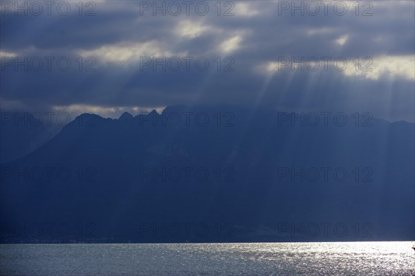 Rays of sunshine break through the clouds on Lake Geneva in Vevey