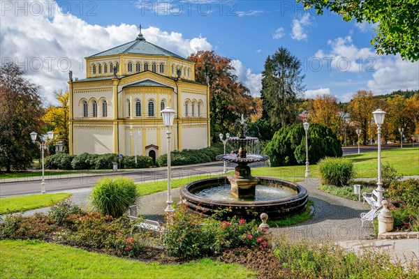 Fountain in front of the Church of the Assumption of Mary in the autumnal spa park