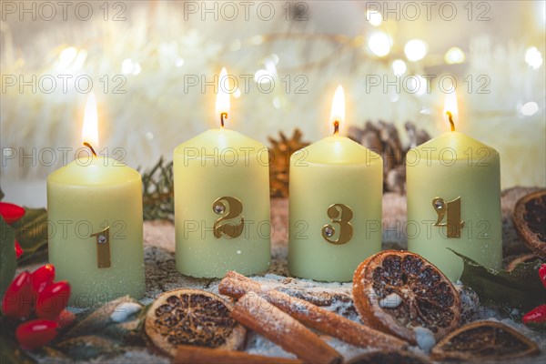Advent candles surrounded by Christmas decorations