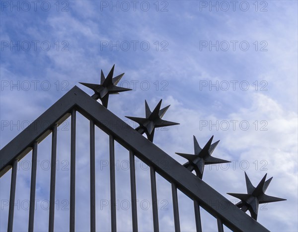 Metal fence with sharp-edged tops
