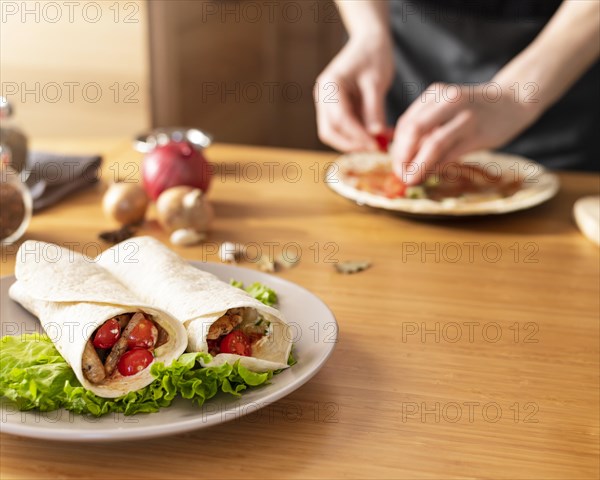 Close up hands preparing dish