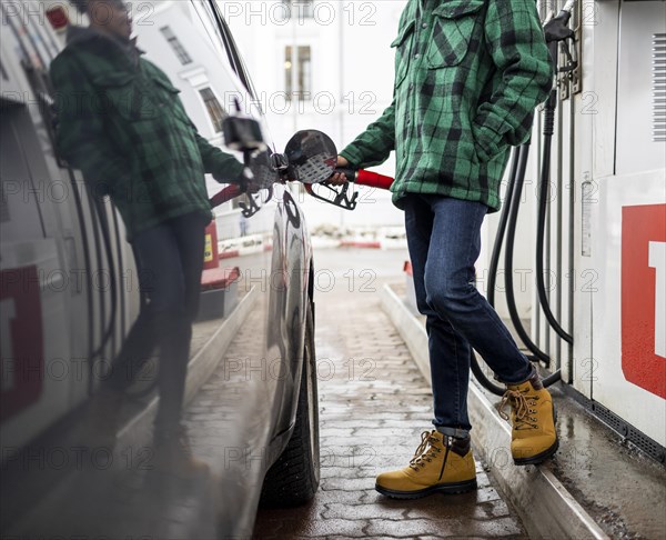 Close up man with car gas station