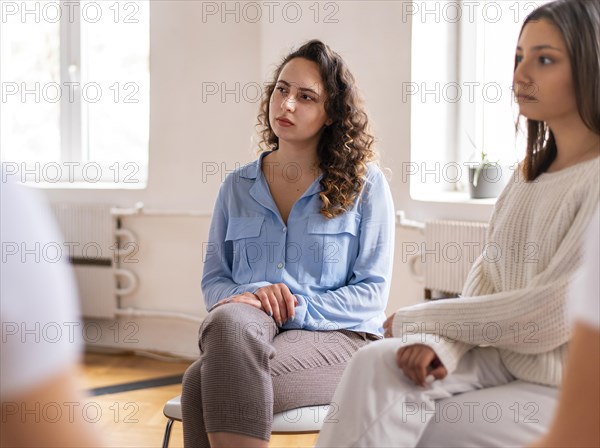 Close up women sitting chairs