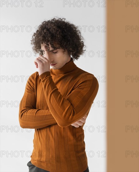 Curly man with brown blouse posing