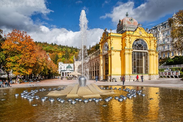 Spa colonnade with singing fountain in the autumnal spa park