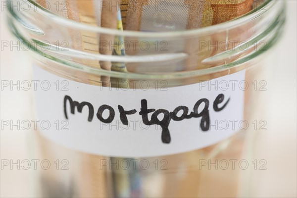 Euro notes saving mortgage glass jar