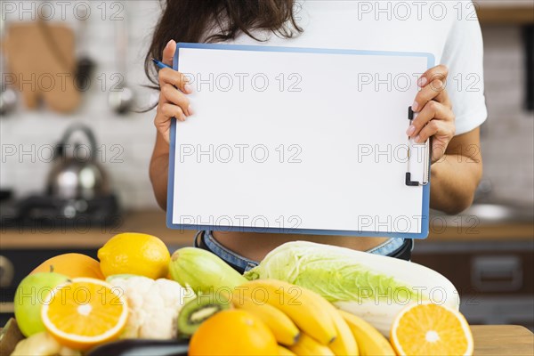 Close up person holding up clipboard