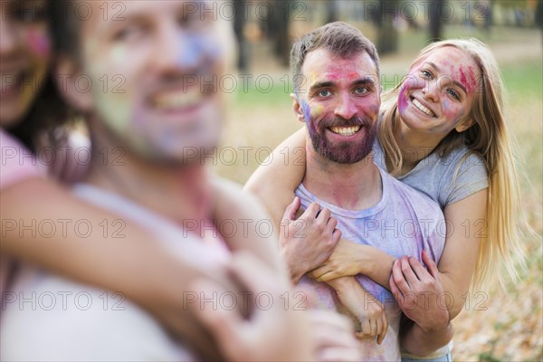 Defocused couple holding each other holi