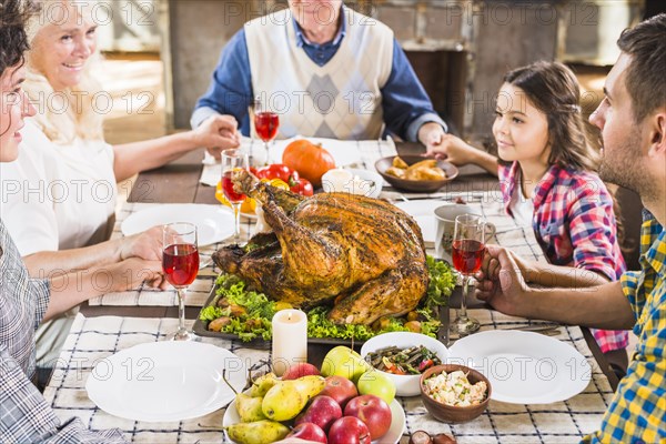 Happy family holding hands table