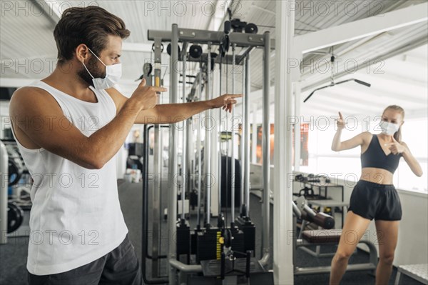 Man woman saluting each other gym