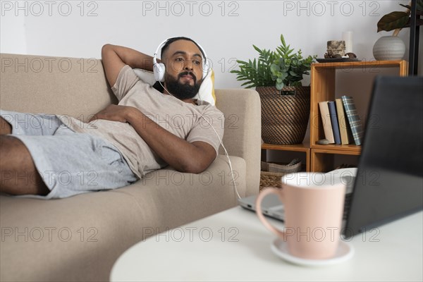 Medium shot man laying couch