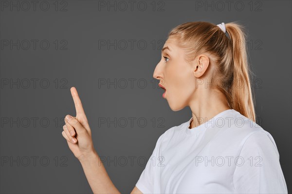 Young woman recognized a method or solution and raised her index finger up