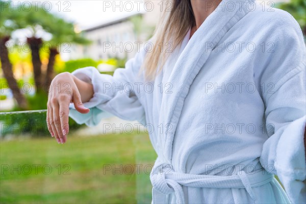 Close-up of a woman wearing bathrobe in the terrace of an hotel