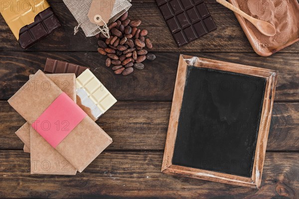 Chocolate bar stack blank wooden slate cocoa beans powder table