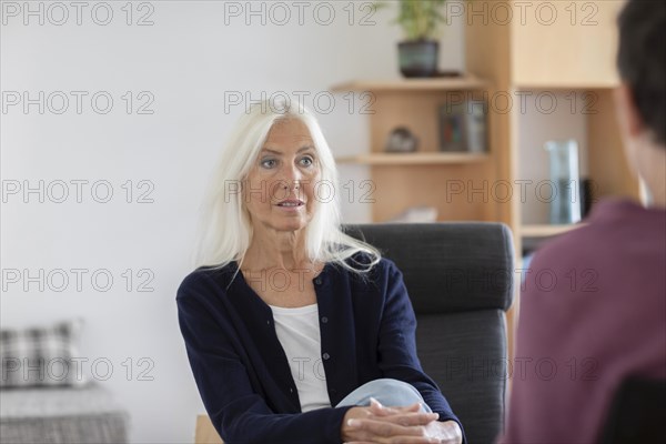 Therapist talking to a patient in a practice